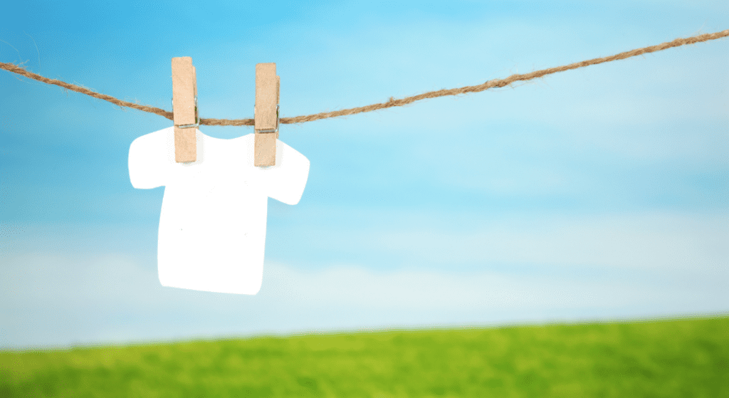 white shirt hanging on string with clips