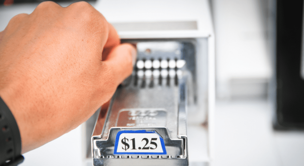 inserting coin in laundry machine
