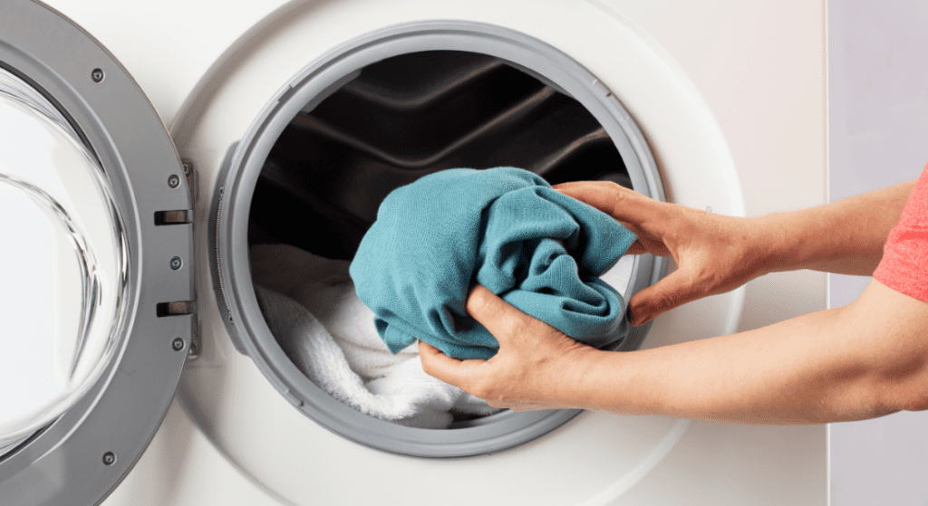 Inserting clothes in laundry machine