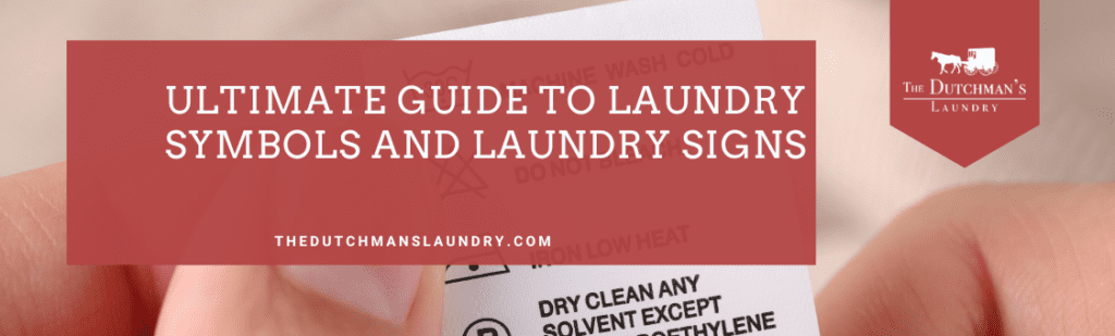 Hands holding a clothing care label in a guide to laundry symbols