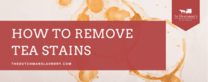 A banner with tea ring stains in the background and a red overlay that reads, "How to Remove Tea Stains," with The Dutchman's Laundry logo in the top right corner.