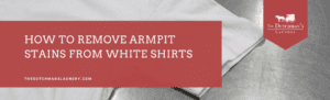 A white shirt on a metallic surface with text: "How to remove armpit stains from white shirts. thedutchmanslaundry.com" and The Dutchman's Laundry logo.