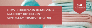 A stack of folded towels and a bottle of detergent with a red banner reading, "How does stain removing laundry detergent actually remove stains?" and The Dutchman's Laundry logo.