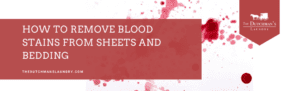 Red blood stains on white fabric with a text overlay reading "How to Remove Blood Stains from Sheets and Bedding - The Dutchman's Laundry.